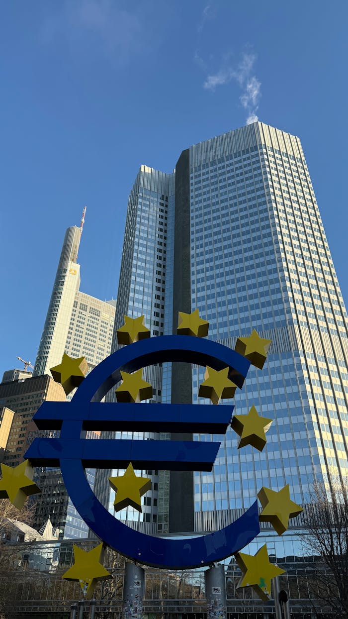 Euro symbol with skyscrapers in Frankfurt, Germany, showcasing urban architecture.
